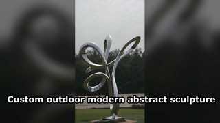 This abstract linear stainless steel mirror sculpture features fluid, interwoven curves