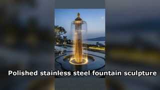 The polished stainless steel fountain sculpture stands in courtyard